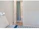 From the bed, a view into the attached bathroom with marble-style walls and a patterned shower curtain at 1365 Dunlin Court, Share C, Kiawah Island, SC 29455