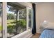 Enjoy the picturesque view from this bedroom window, showcasing lush greenery and a glimpse of a nearby golf course at 1365 Dunlin Court, Share C, Kiawah Island, SC 29455
