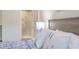 Relaxing bedroom featuring a bed with gray headboard, white pillows, a blue comforter and a shower in the background at 1365 Dunlin Court, Share C, Kiawah Island, SC 29455