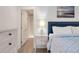 Comfortable bedroom featuring a blue bedspread, a nightstand with lamp, and a view of the bathroom with a shower at 1365 Dunlin Court, Share C, Kiawah Island, SC 29455