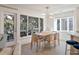 Bright dining room boasts wood floors, contemporary lighting, and scenic outdoor views at 1365 Dunlin Court, Share C, Kiawah Island, SC 29455