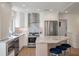 Modern kitchen features stainless steel appliances, granite countertops, and an island with barstool seating at 1365 Dunlin Court, Share C, Kiawah Island, SC 29455