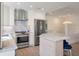 Modern kitchen features stainless steel appliances, marble countertops, and ample storage at 1365 Dunlin Court, Share C, Kiawah Island, SC 29455