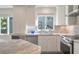 A kitchen with granite countertops, stainless steel appliances, and white cabinets at 1365 Dunlin Court, Share C, Kiawah Island, SC 29455
