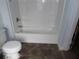 The bathroom has a white tub/shower unit and a white toilet on a tile floor at 1382 Doctor Evans Rd, Moncks Corner, SC 29461