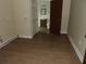 The room features a wood-look floor and a doorway leading to a bathroom at 1382 Doctor Evans Rd, Moncks Corner, SC 29461