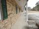 The home's brick exterior features green shutters, a covered porch, and a concrete path at 1382 Doctor Evans Rd, Moncks Corner, SC 29461