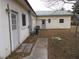 Exterior view of the back of a building with light yellow siding and a metal roof at 1382 Doctor Evans Rd, Moncks Corner, SC 29461