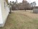 Spacious side yard offering potential for landscaping or outdoor activities with easy access to side house entrance at 1382 Doctor Evans Rd, Moncks Corner, SC 29461