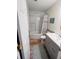 Bathroom with a white marble-esque shower, updated vanity and wood-look flooring at 1402 Camp Rd # 15H, Charleston, SC 29412