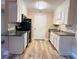 Bright kitchen features white cabinets, black appliances, granite countertops, and modern flooring for a stylish cooking space at 1402 Camp Rd # 15H, Charleston, SC 29412