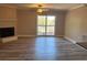 Spacious living room with fireplace and sliding glass doors to balcony, featuring modern flooring and plenty of natural light at 1402 Camp Rd # 15H, Charleston, SC 29412