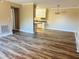 Open-concept living room with luxury vinyl floors and views of the kitchen at 1402 Camp Rd # 15H, Charleston, SC 29412