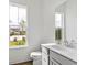 Clean, well-lit bathroom featuring a white vanity, modern fixtures, and a large window at 144 Maritime Way, Summerville, SC 29485