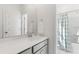 Well-lit bathroom with shower and tub, and a gray vanity with white countertop and sink at 144 Maritime Way, Summerville, SC 29485