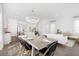 Open-concept dining area with a modern chandelier, seamlessly connected to the kitchen and living room at 144 Maritime Way, Summerville, SC 29485