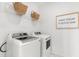 Bright laundry room with updated washer and dryer, wire rack shelving and decorative accents at 144 Maritime Way, Summerville, SC 29485