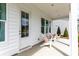 Comfortable porch area featuring Adirondack chairs with pink pillows and potted shrubs at 144 Maritime Way, Summerville, SC 29485