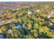 Aerial view of residences near a golf course and waterways, surrounded by dense green trees at 16 Twin Oaks Lane Ln, Isle of Palms, SC 29451