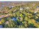 Aerial view of a home nestled amongst trees near a golf course and scenic marshland at 16 Twin Oaks Lane Ln, Isle of Palms, SC 29451