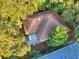 Aerial view of a charming home with a brown roof nestled among lush trees and a private deck at 16 Twin Oaks Lane Ln, Isle of Palms, SC 29451