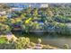 Beautiful aerial view of a waterfront home near a pool and a body of water with neighborhood at 16 Twin Oaks Lane Ln, Isle of Palms, SC 29451
