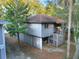 Exterior view of an elevated beach home with weathered gray siding and stairs leading to the entrance at 16 Twin Oaks Lane Ln, Isle of Palms, SC 29451