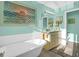 Charming bathroom with a clawfoot tub, decorative art, and a stylish vanity with ample lighting at 1608 Marsh Harbor Ln # C, Mount Pleasant, SC 29464