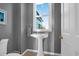 Charming powder room featuring pedestal sink, stylish wallpaper, and natural light at 1608 Marsh Harbor Ln # C, Mount Pleasant, SC 29464