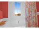 Bright bathroom featuring a tub, coral-themed shower curtain, and a window with a view of the outdoors at 1608 Marsh Harbor Ln # C, Mount Pleasant, SC 29464