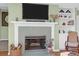 Inviting fireplace with decorative tile surround, built-in shelving, and mounted television at 1608 Marsh Harbor Ln # C, Mount Pleasant, SC 29464