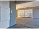 Spacious garage with white vertical bars letting light through and a white door to a storage unit at 1608 Marsh Harbor Ln # C, Mount Pleasant, SC 29464