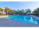 Beautiful community pool surrounded by palm trees and colorful beach homes at 1608 Marsh Harbor Ln # C, Mount Pleasant, SC 29464