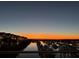 Scenic water view at sunset featuring a line of boat docks, row houses and a colorful sky at 1608 Marsh Harbor Ln # C, Mount Pleasant, SC 29464