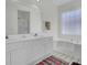 Well-lit bathroom with double sinks, tub, and shower, offering a relaxing and functional space at 1652 Camfield Ln, Mount Pleasant, SC 29466
