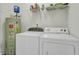 Functional laundry area with washer, dryer, and storage shelves, making chores convenient and organized at 1652 Camfield Ln, Mount Pleasant, SC 29466
