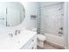 Bright bathroom features updated vanity, round mirror, shower and tub with tile and blue patterned curtain at 1712 Chatelain Way, Mount Pleasant, SC 29464