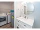 Bright bathroom with updated sink, cabinet, light fixtures, and adjacent laundry appliances at 1712 Chatelain Way, Mount Pleasant, SC 29464