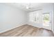 A bright bedroom with wood-look flooring and a door to the outside at 1712 Chatelain Way, Mount Pleasant, SC 29464