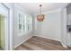 Bright dining room with wood floors, plantation shutters, and modern lighting fixture at 1712 Chatelain Way, Mount Pleasant, SC 29464