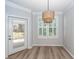 A stylish dining area with exterior access and plantation shutters for plenty of light at 1712 Chatelain Way, Mount Pleasant, SC 29464
