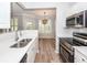 The kitchen features stainless appliances, light countertops and view to the dining area with shutters at 1712 Chatelain Way, Mount Pleasant, SC 29464