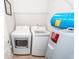 Bright laundry area with stacked machines and water heater at 1712 Chatelain Way, Mount Pleasant, SC 29464