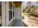 View of a covered patio with green siding, a white door, concrete flooring, and AC unit at 1712 Chatelain Way, Mount Pleasant, SC 29464