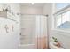 Bright bathroom with white shower curtain, white tile, and window at 1714 Banning St, Mount Pleasant, SC 29466