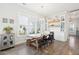 Inviting dining room features a large wooden table, stylish lighting, and ample natural light from large windows at 1714 Banning St, Mount Pleasant, SC 29466