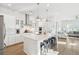 Bright, open kitchen with white cabinetry, stainless steel appliances, and a large island with bar stool seating at 1714 Banning St, Mount Pleasant, SC 29466