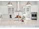 Bright kitchen with stainless steel appliances, white cabinetry, and stylish pendant lighting at 1714 Banning St, Mount Pleasant, SC 29466