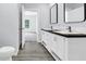 Modern bathroom featuring a double vanity with black countertop, white cabinetry, and gray walls at 183 Waverly Rd, Walterboro, SC 29488