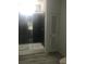 Bright bathroom features glass-enclosed shower with black tile, showcasing modern design at 183 Waverly Rd, Walterboro, SC 29488